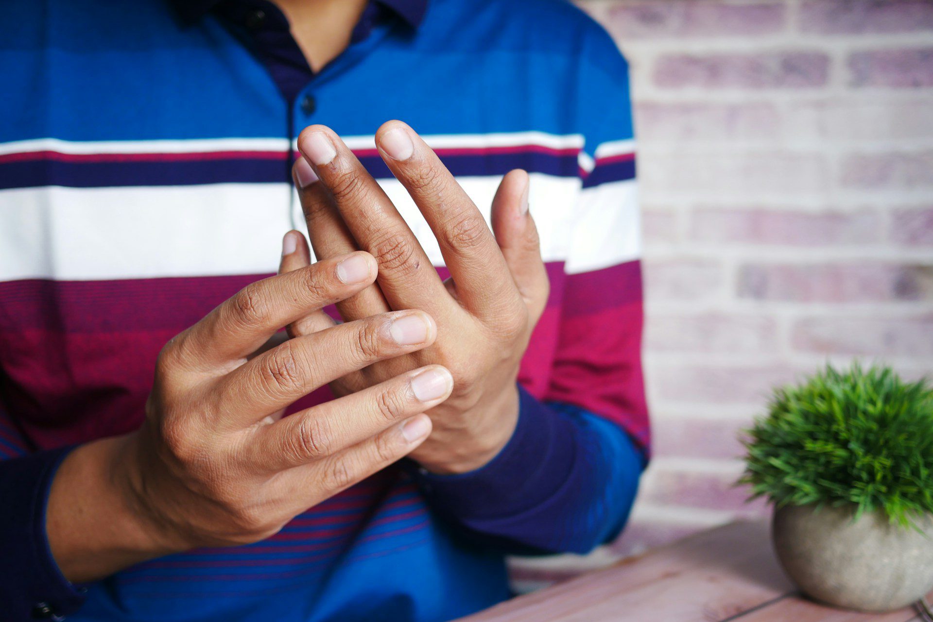 Man suffering pain in hand close up.